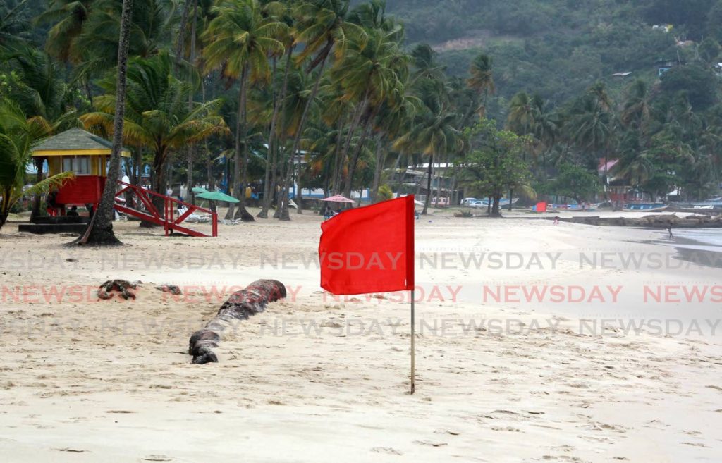 A red flag place on the shoreline warning swimmers of the rough sea conditions at Maracas Beach. - File photo by Roger Jacob