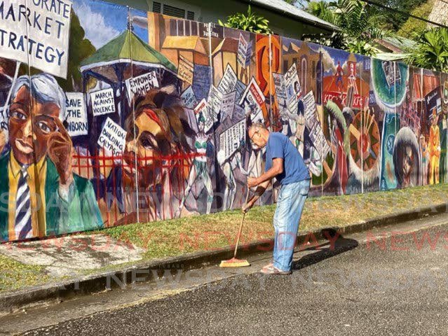 Artist Jackie Hinkson keeps a clean scene at his outdoor Carnival-themed exhibition. - 