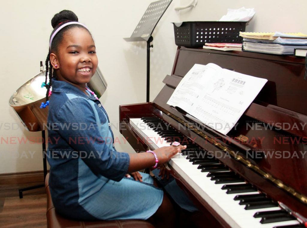 Melody Nicholas plays the piano at her home in Hillcrest Gardens, San Fernando. Her grandmother Bernadette Roberts, a retired school music teacher, teaches her the piano and pan. - 