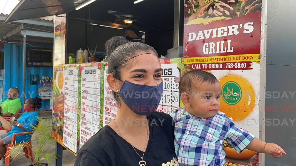 Darilis Martinez and her son Davier. The food truck Davier's Grill is named after her son who was born six months ago. Photo by Kalifa Sarah Clyne