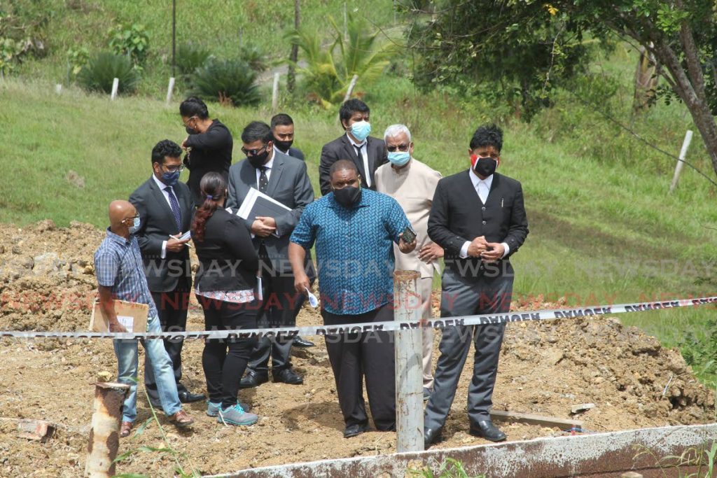 CEMETERY SITE VISIT: Justice Frank Seepersad visited the Monkey Town Public Cemetery, Barrackpore, on Tuesday to determine if a family's burial plot was disturbed by roadworks undertaken by the Penal/Debe Regional Corporation. Photos by Lincoln Holder