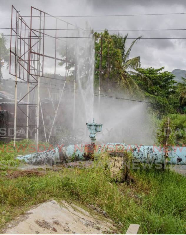 In this December 2018 file photo, a broken water main spews gallons of water down the drain off Beetham Highway, Port of Spain. - JEFF MAYERS