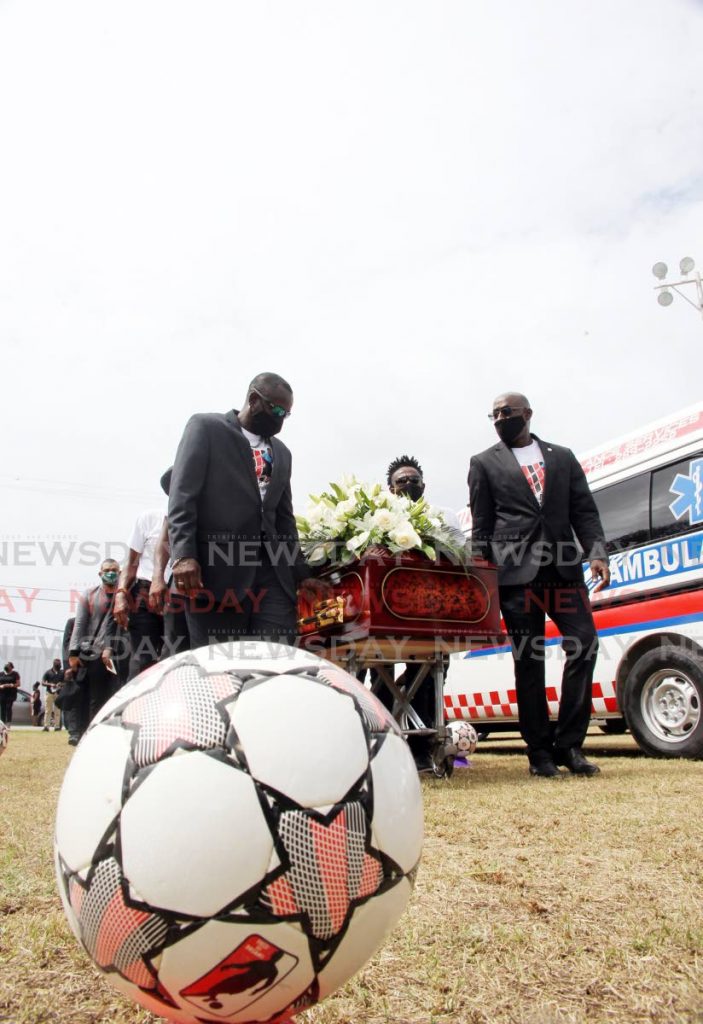 Former Strike Squad members carry the casket of former team-mate Larry Joseph at his funeral, on Wednesday, at the La Brea Recreation Ground, La Brea. Joseph passed away on February 17. He was 56. - Lincoln Holder