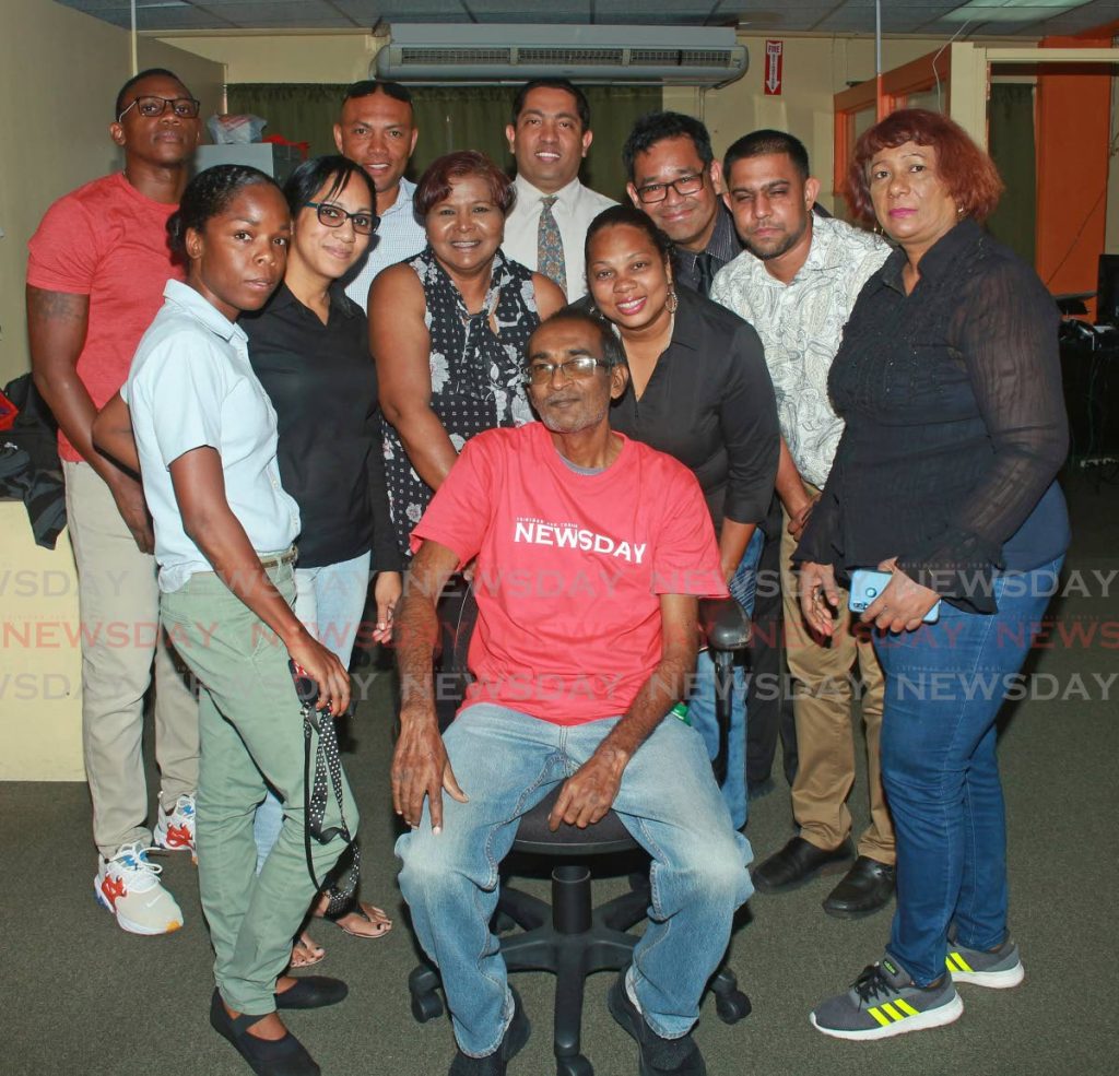 Richardson Dhalai, centre, surrounded by his former colleagues as he retires from Newsday on February 28, 2020. - 