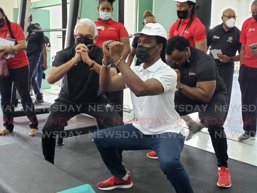 Minister of Health Terrence Deyalsingh, from left, Minister of Youth Development and National Service Fitzgerald Hinds and MP for Port of Spain South, Keith Scotland do squats at the opening of the Healthy Youth TT gym facility at St James Youth Centre on Saturday. PHOTO BY JANELLE DE SOUZA - 