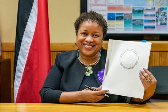 Acting Planning and Development Minister Allyson West displays her copy of the loan agreement with the Inter-American Development Bank for US$24.5m to help the most vulnerable affected by the covid19 pandemic. - Photo courtesy Ministry of Planning and Development