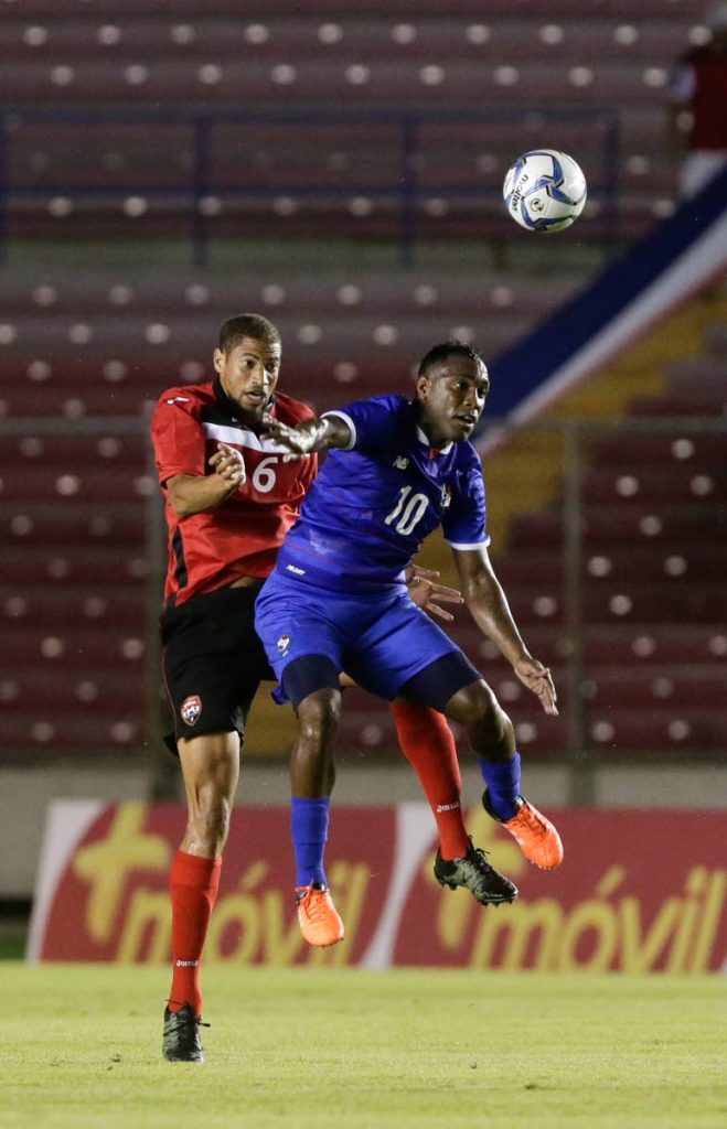 TT's Radanfah Abu Bakr (left) heads away under pressure from Panama's Luis Tejada during a 2015 friendly in Panama. - AP