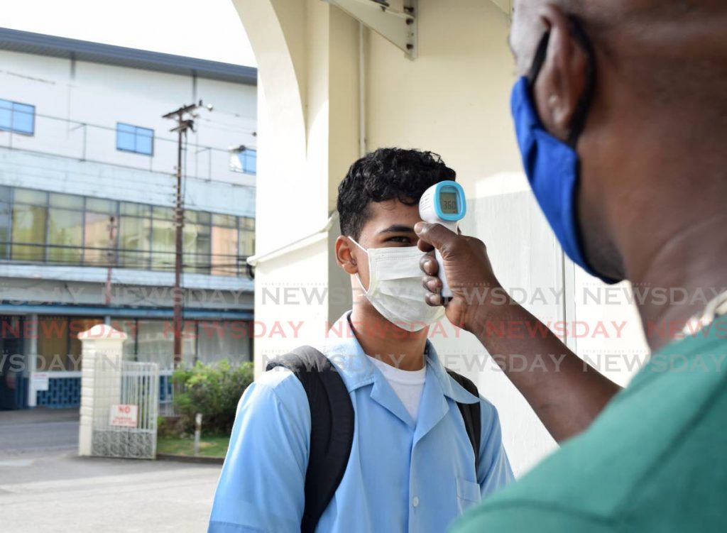 A student has his temperature taken as part of covid19 health protocols at a secondary school in Port of Spain in July 2020. Secondary schools are due to reopen on Monday. File photo - 