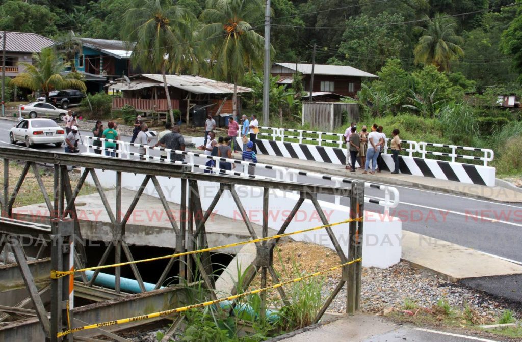 Residents and Ministry of Works and Transport officials on the Mamoral Bridge when it was opened in October 2020. The Prime Minister on Friday said withdrawals from the Heritage and Stabilisation Fund support the Consolidated Fund which finances development projects such as building bridges. File photo - 