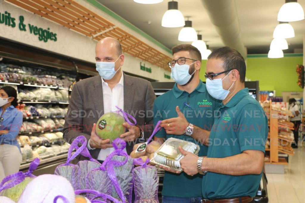 Agostini Group chairman Christian Mouttet, left, at the launch of fresh produce at the Presto Market in Trincity. Alongside Mouttet are SuperPharm business development representative Jean-Luc Mouttet and SuperPharm CEO Glen Maharaj in December 2020. SuperPharm is part of the Agostini Group which has acquired pharmaceutical companies Oscar Francois Ltd and Intersol Ltd. File photo - 