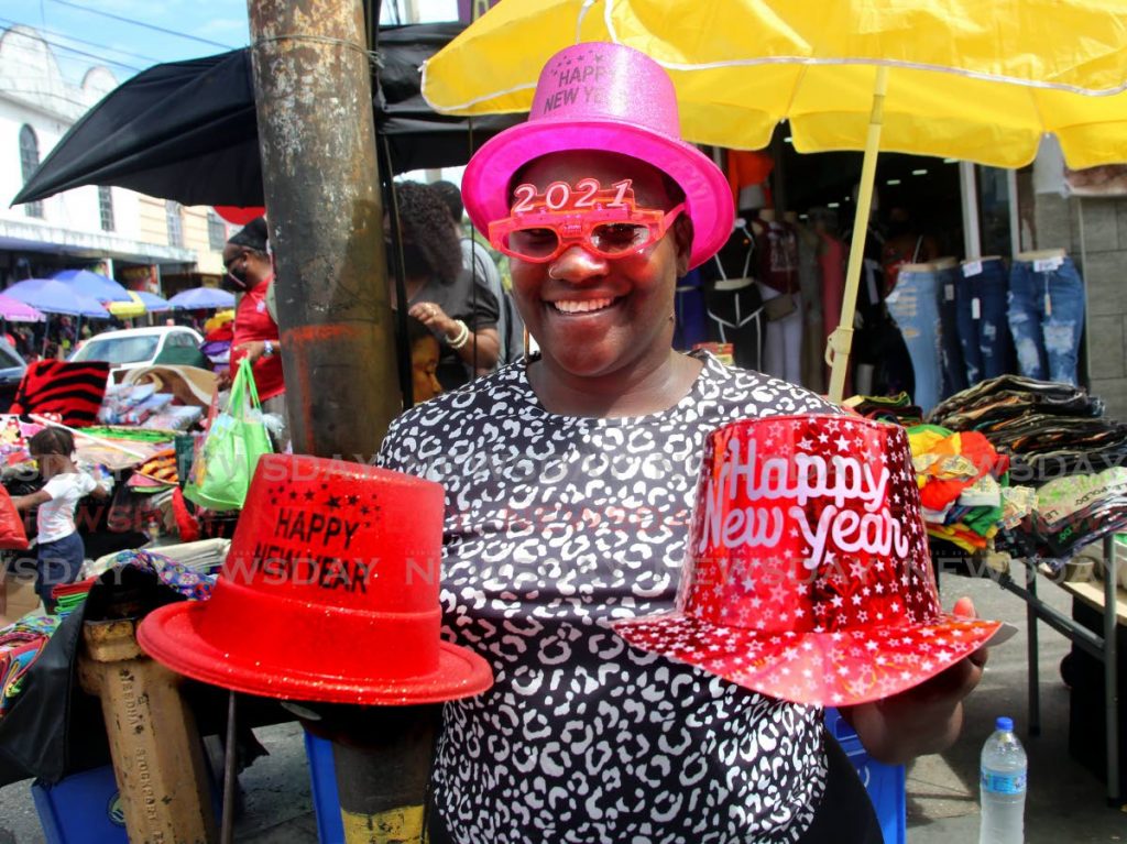 A vendor on Charlotte Street selling 2021 New Year's hats on December 31, 2020. Holiday festivities led to more than 400 covid19 cases in January, health officials report. File photo - 