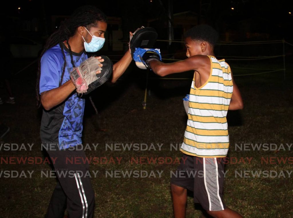 Trainer Jarel Nunes, left, trains a member of the Holistic Boxing Academy, Malabar recently. - Angelo Marcelle