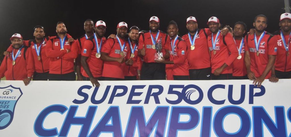 Red Force players celebrate with the Super50 trophy after beating Guyana Jaguars in the final at the Coolidge Cricket Ground, Antigua, Saturday. - CWI Media