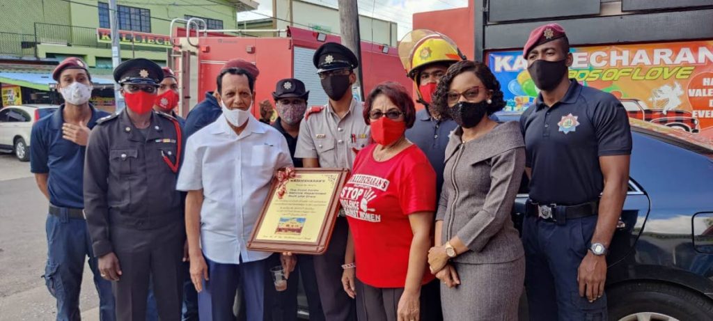 Vishnu Kalliecharan (second from left) awarded a plaque of honour to fire officers from Point Fortin who saved one of his buildings on October 5, 2020. Photo provided by Leah Figaro. - 