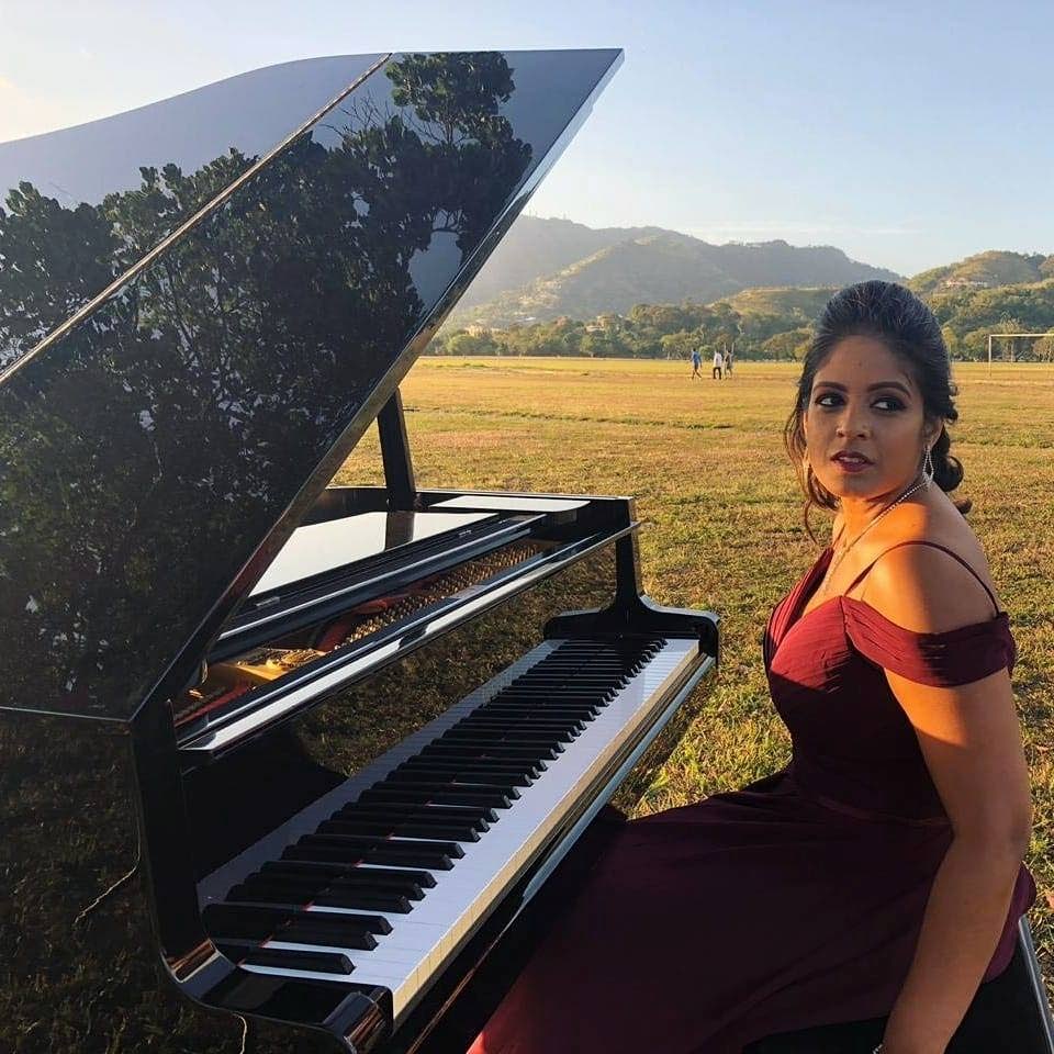 Johanna Chuckaree aka D Piano Girl Johanna performs on a baby grand piano to an empty Grand Stand, Queen's Park Savannah, Port of Spain, in the video of her song We'll Go On. The song is a collaboration with Vincentian artiste Skinny Fabulous. - 