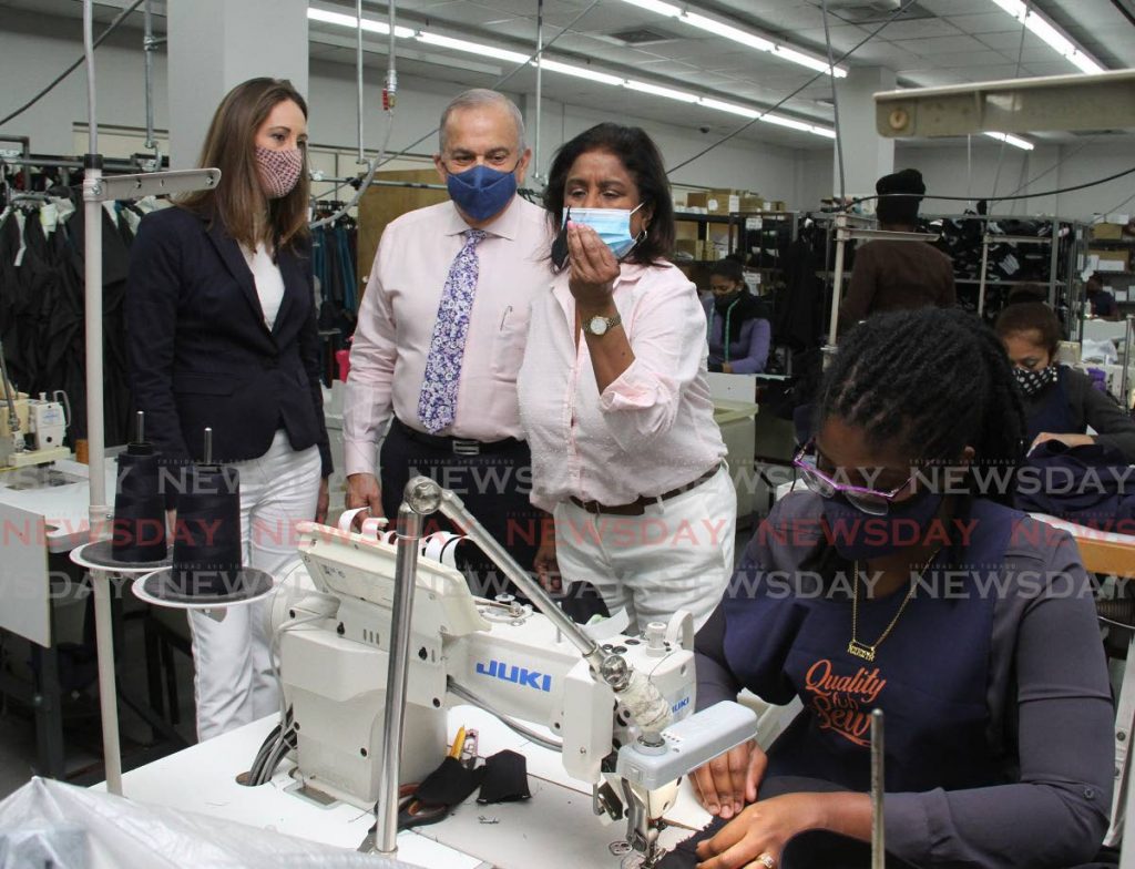 Trade Minister Paula Gopee-Scoon, right, and TT Manufacturers' Association president Franka Costelloe, left, tour Janouras Custom Design Limited in Chaguanas with chairman and managing director George Janoura on Wednesday. - Angelo Marcelle