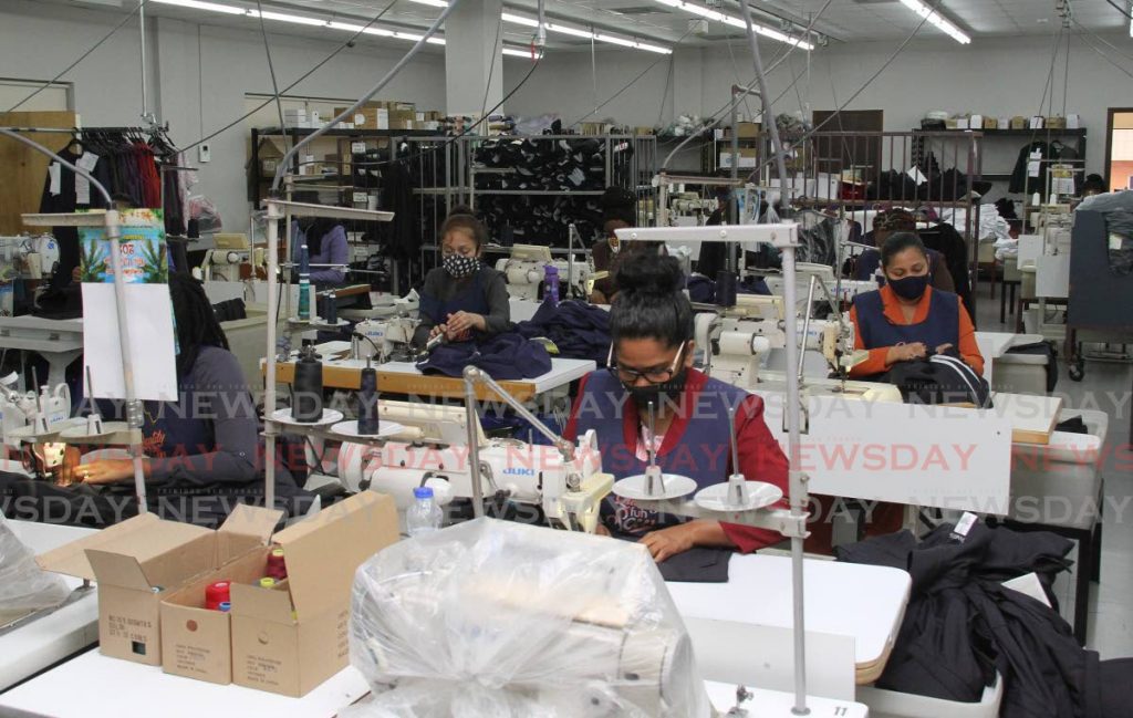 Janouras Custom Design Ltd employees, sew garments in the production room, at the company's Manic St. Chaguanas location on Wednesday. The Minister of Trade and Industry was invited to tour the facilities. - Angelo Marcelle