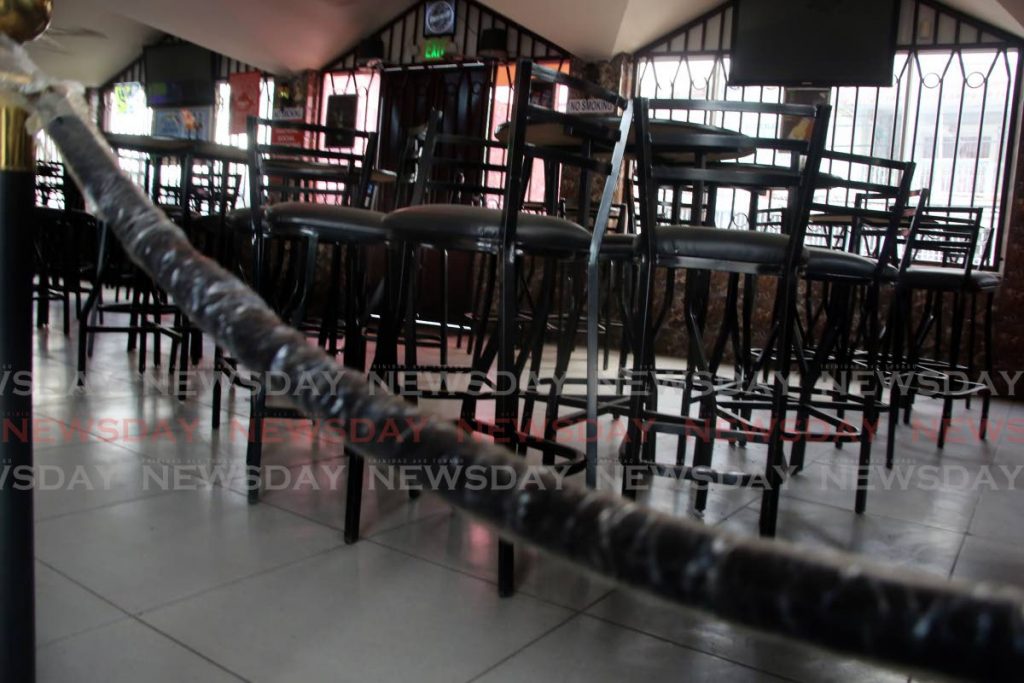 Chairs at Nari's Pub in Barataria are cordoned off from patrons. PHOTO BY SUREASH CHOLAI - SUREASH CHOLAI