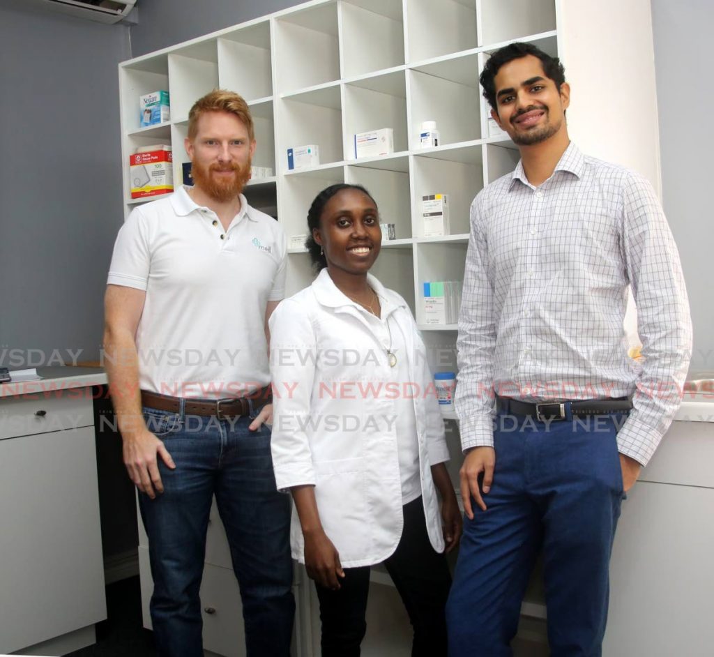 Edward Inglefield (left) and Kiran Mathur Mohammed (right), co-founders of local medicine delivery app medl with chief pharmacist Katisha Narinesingh. PHOTOS BY SUREASH CHOLAI
 - 