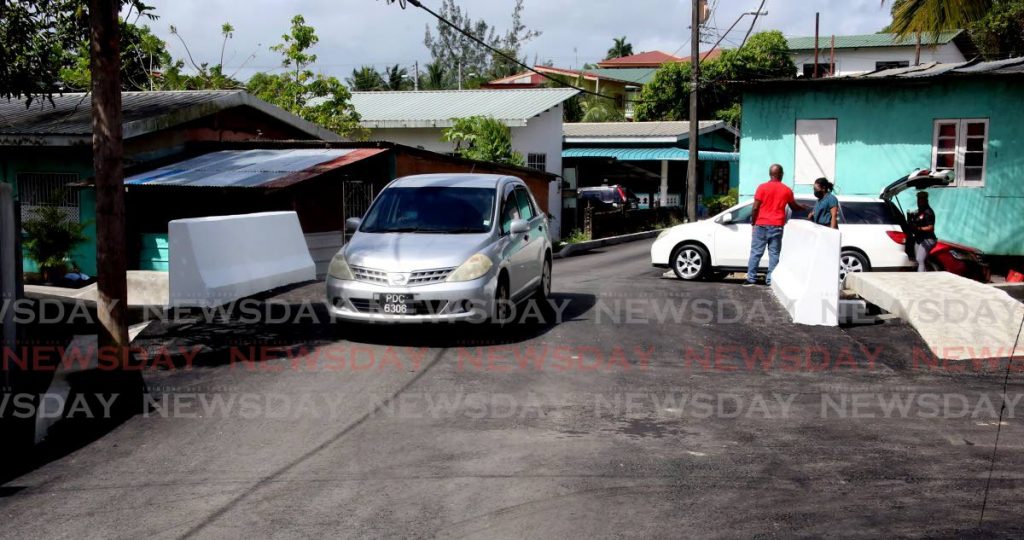 A motorist drives over the new Peytonville bridge, Kelly Trace, O'Meara Road (South), Arima on Saturday. PHOTO BY SUREASH CHOLAI - 