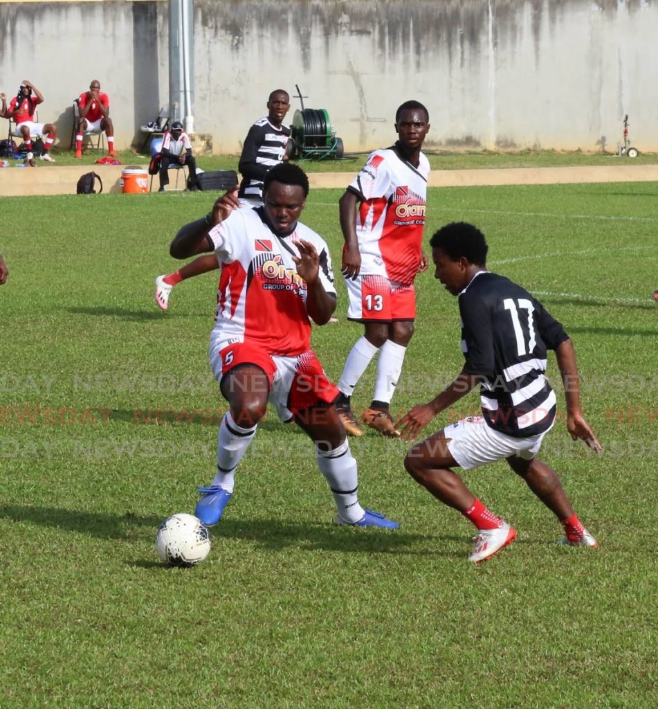 TT footballer Sean Bonval, right, puts pressure on Jahiem Harry of the Tobago XI in a TT practice match at the St James Police Barracks in St James, on Saturday. PHOTO BY SUREASH CHOLAI - Sureash Cholai