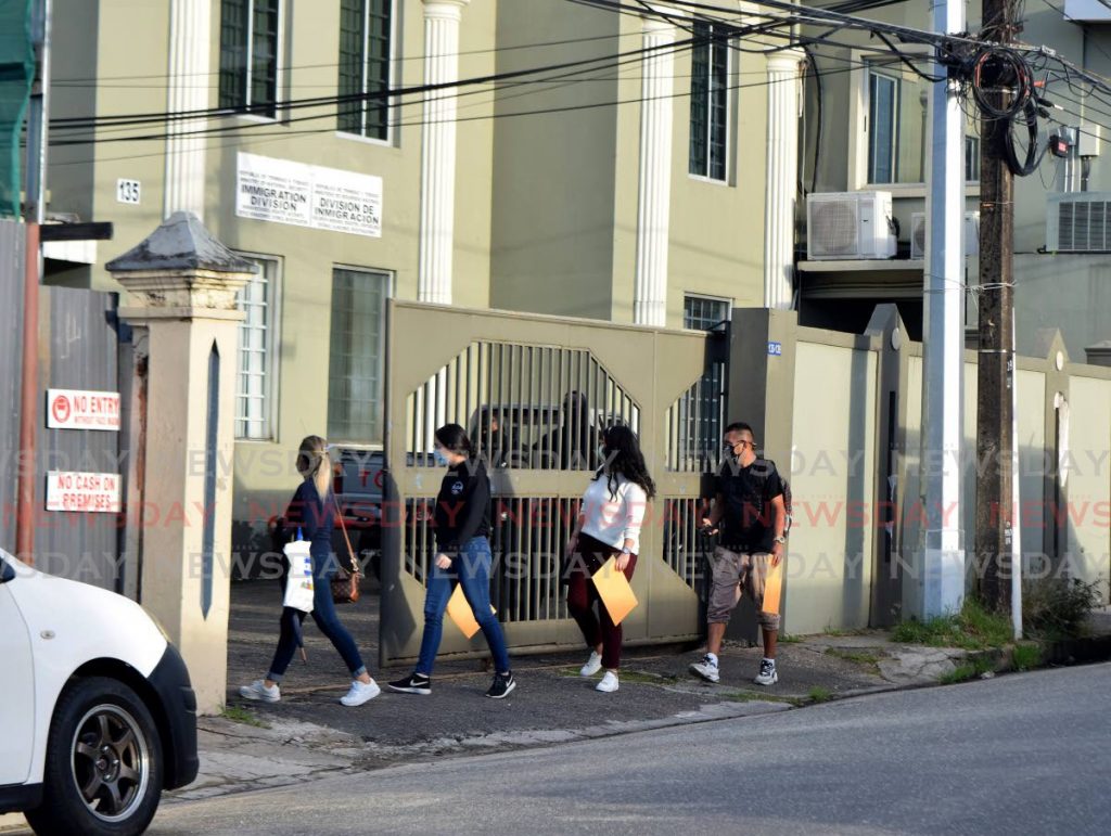 In this file photo, Venezuelan nationals enter Immigration Division on Henry Street, Port of Spain, to drop off re-registration forms and other documents. Photo by Vidya Thurab