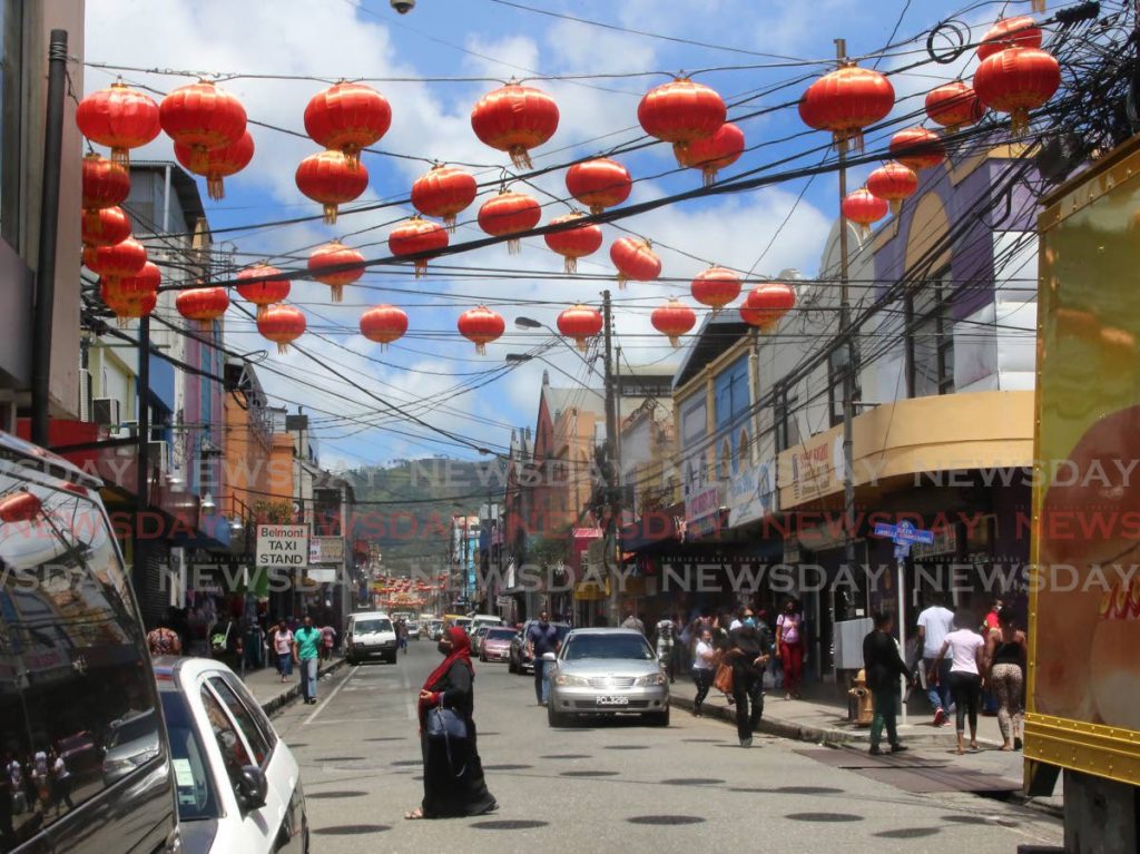 Beautiful red chinese lanterns hanging overhead in Chinatown (Charlotte Street) in Port of Spain. - SUREASH CHOLAI