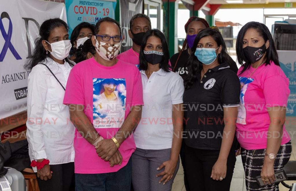 Randolph Bharatt, front, father of murder victim Andrea Bharatt, with founder of People Against Domestic Abuse Dr Kamane Soman, centre, Candlelight Movement PRO Kandace Bharath and  supporters at a petition signing on Thursday at Port Mall, Scarborough, Tobago. - DAVID REID 