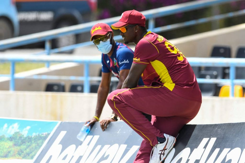 Jason Holder (right) and Kraigg Brathwaite of the West Indies speak to each other during the 2nd ODI match between West Indies and Sri Lanka at the Sir Vivian Richards Cricket Stadium, North Sound, Antigua on Friday. (AFP PHOTO) - 