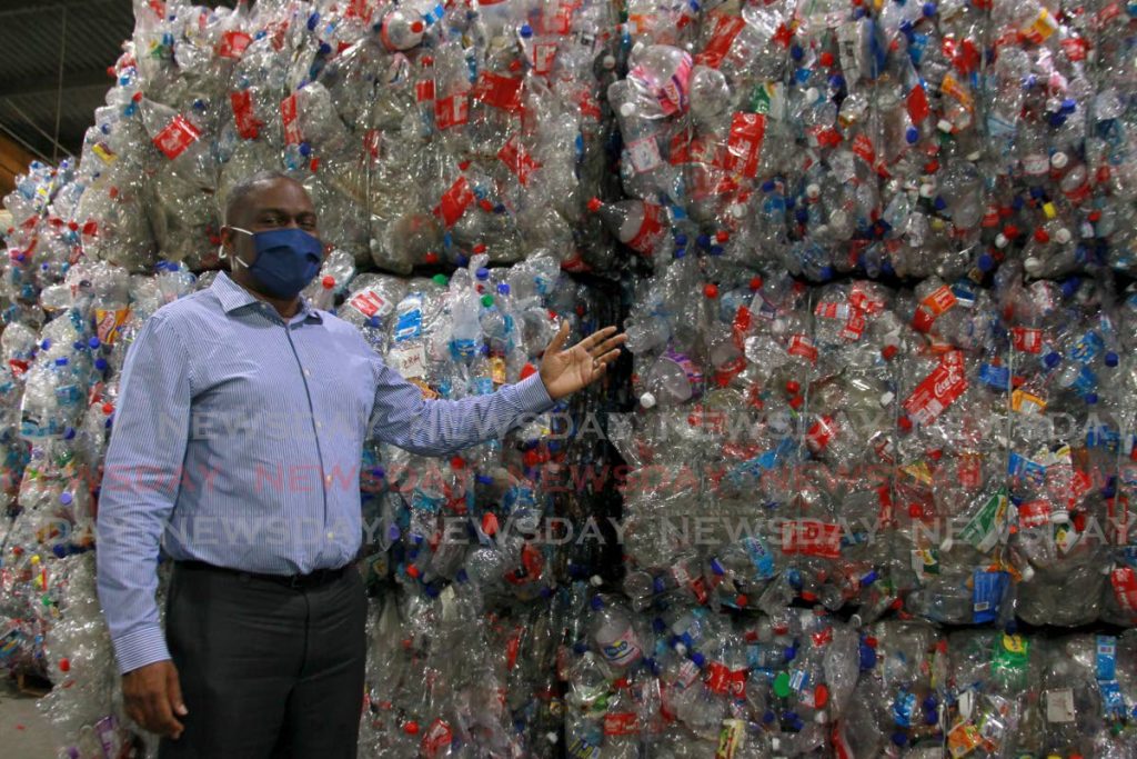 Solid Waste Management Co Ltd CEO Kevin Thompson points to compressed plastic bottles at the company's recycling warehouse in Sea Lots, Port of Spain. Photo by Roger Jacob- 