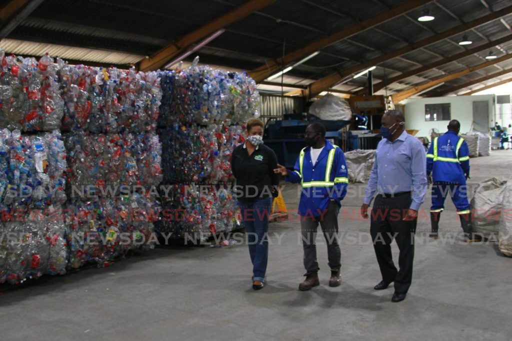 From left: SWMCOL recycling and recovery unit manager Terry-Anne Carter-La Fon, PET plant supervisor Sheldon Smith and CEO Kevin Thompson at the company's recycling warehouse in Sea Lots on Friday. - ROGER JACOB