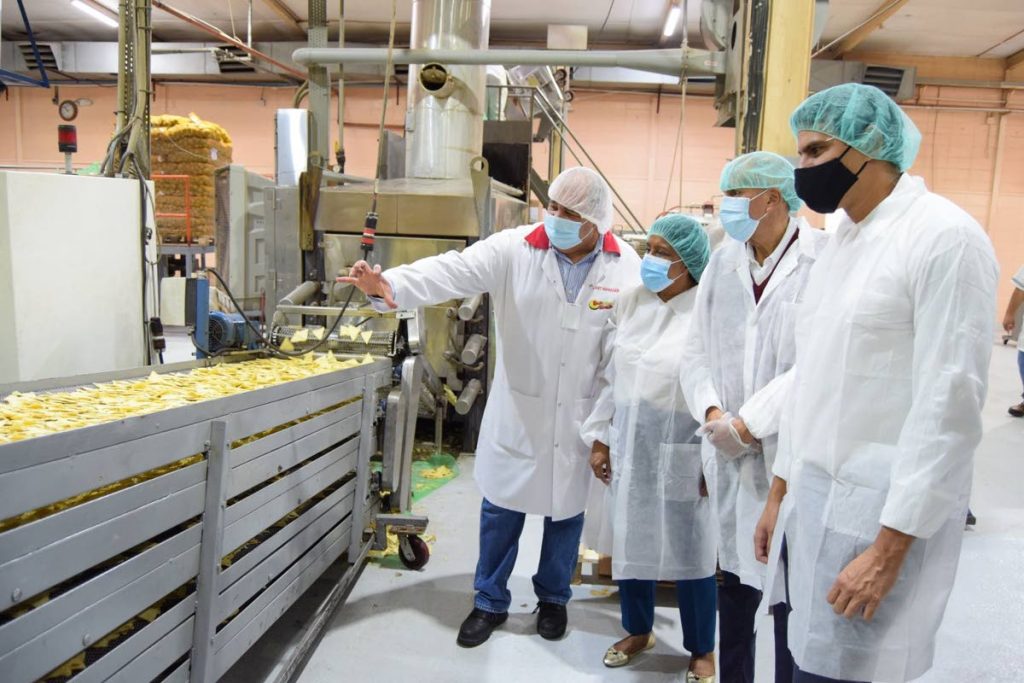 In this file photo, Trade and Industry Minister Paula Gopee-Scoon, Associated Brands Industries Ltd (ABIL) chairman Arthur Lok Jack, centre, and ABIL deputy chairman and CEO Nicholas Lok Jack at a tour of a factory -
