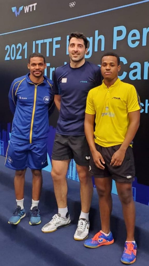 Table tennis coach Sherdon Pierre (TT), left, and his Bajan student Tyrese Knight (right) with veteran Greek table tennis player and coach Gionis Panagiotis at last week's ITTF High Performance camp in Qatar.   - 
