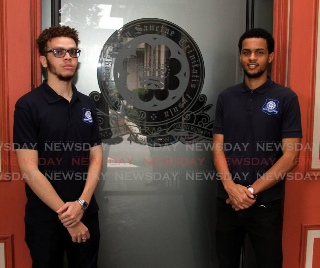  Queen's Royal College (QRC) open scholarship winner Nico Brewster,right, and Barbados exhibition winner ILijah Corbin, left, at the school in Port of Spain on Sunday. - Angelo Marcelle