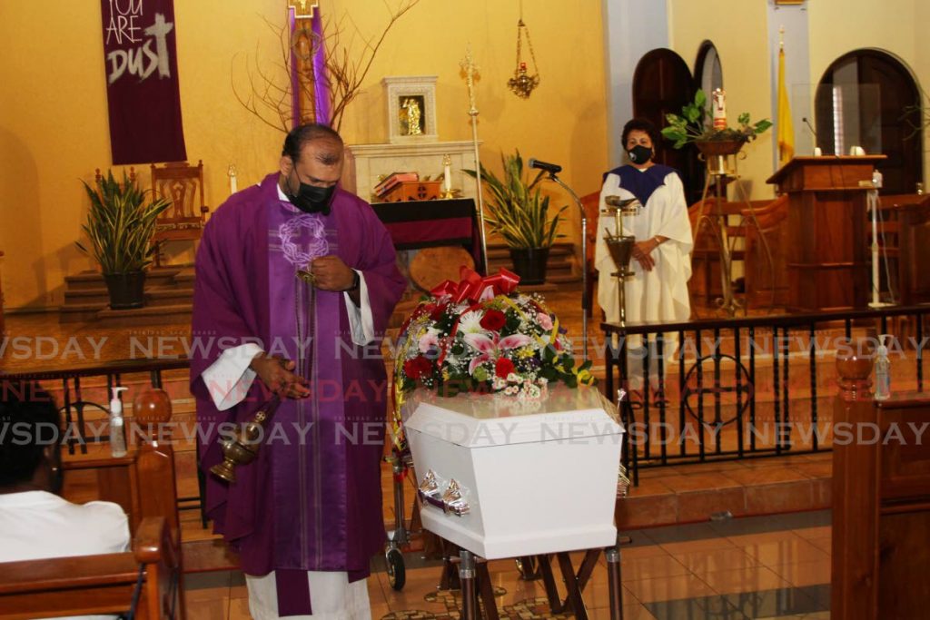 RC priest Fr David Khan incenses the coffin of Adeina Alleyne at the Our Lady of Perpetual Help RC Church, Harris Promenade, San Fernando on Monday. - Marvin Hamilton