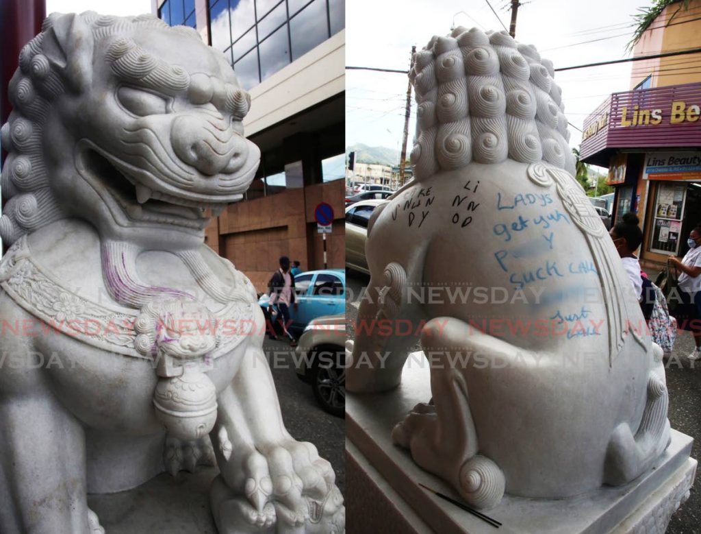 Graffiti on the stone statue at the top of Charlotte Street, Port of Spain. - 