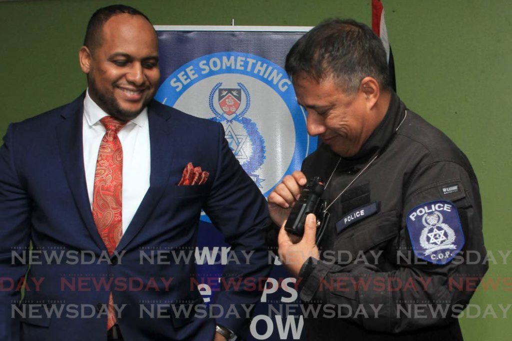 Police Commissioner Gary Griffith puts on a body camera to show how it is used during press briefing at the Police Administration Building, Port of Spain on June 18, 2020. At left, is head of the police legal unit Christian Chandler. File photo/Ayanna Kinsale - 