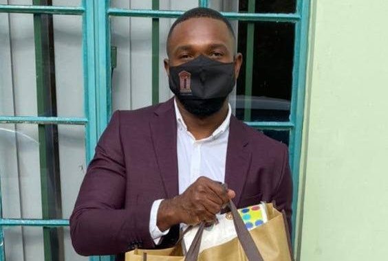 Black Rock/Whim/Spring Garden assemblyman Kelvon Morris holds up a food/clothing hamper outside of his electoral office at Plymouth Road, Whim, on Friday.  - 
