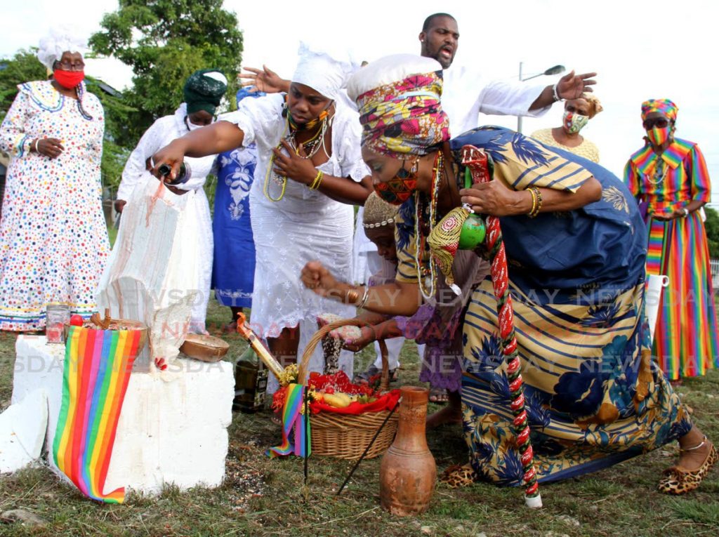These ladies pay homage to the ancestors during the National Council of Orisha Elders day of prayer at the Emancipation/Ancestral grounds, Lopinot Bon Air West, Arouca. Photo by Ayanna Kinsale