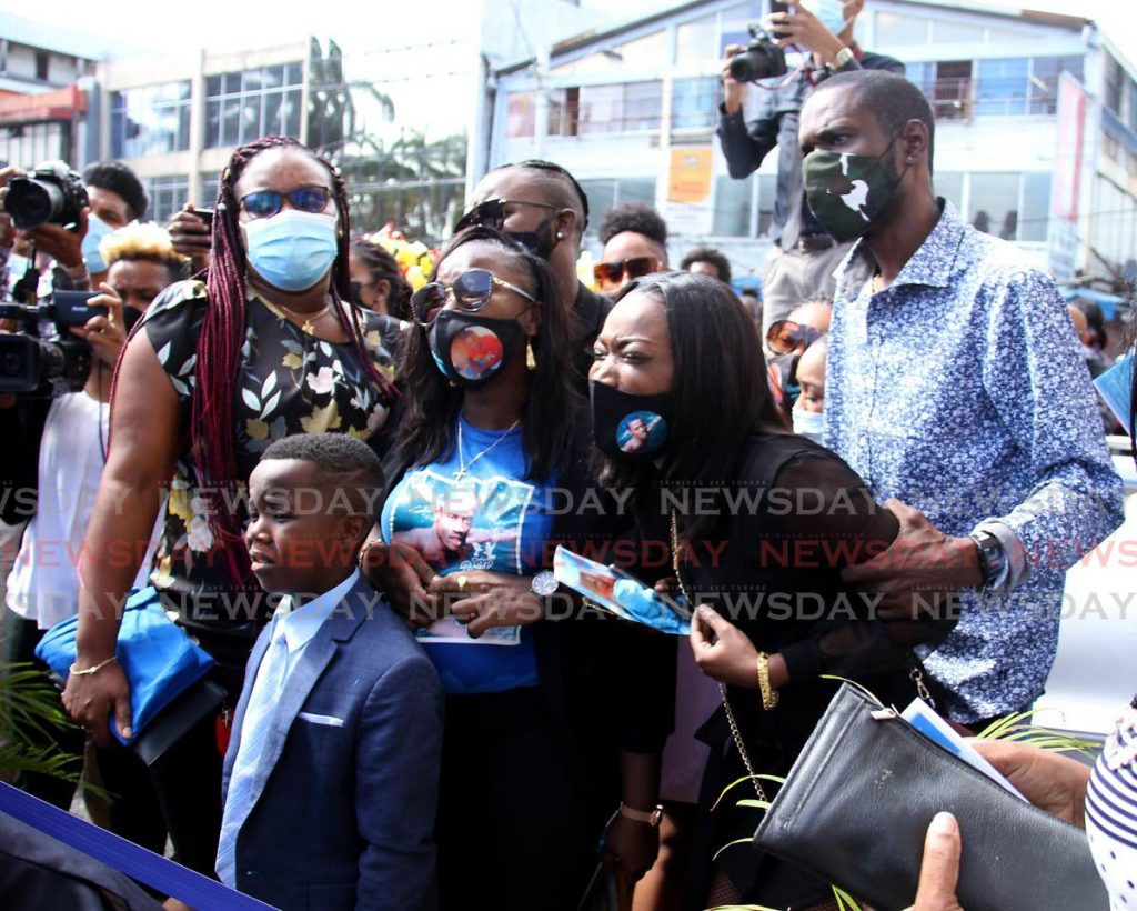 Mother of Jevon Clairmont, Takeisha Clairmont, centre, is consoled by family members during his funeral service at the Cathedral of the Immaculate Conception, Independence Square, Port of Spain. - Photo by Ayanna Kinsale