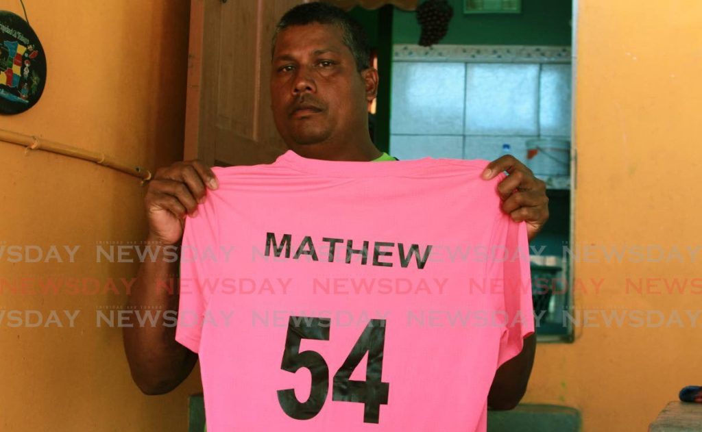 Marlon Sookoo showing his son's favourite number 54 cricket jersey. He looked up to West Indies batsman Lendl Simmons, who wears that number. Sookoo fell overboard on Saturday. His body was found on Monday morning.  Photo by Marvin Hamilton