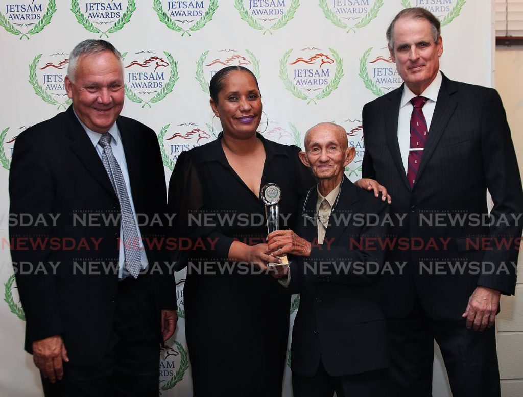In this February 27, 2018 file photo, former Mayor of Arima Lisa Morris-Julian presents Arima Race Club employee Maxie Assee with an award during the 2018 Jetsam Awards ceremony, at Queen's Park Oval, Port of Spain. Arima Race Club vice president John O'Brien, left, and general manager Anthony White look on. - 