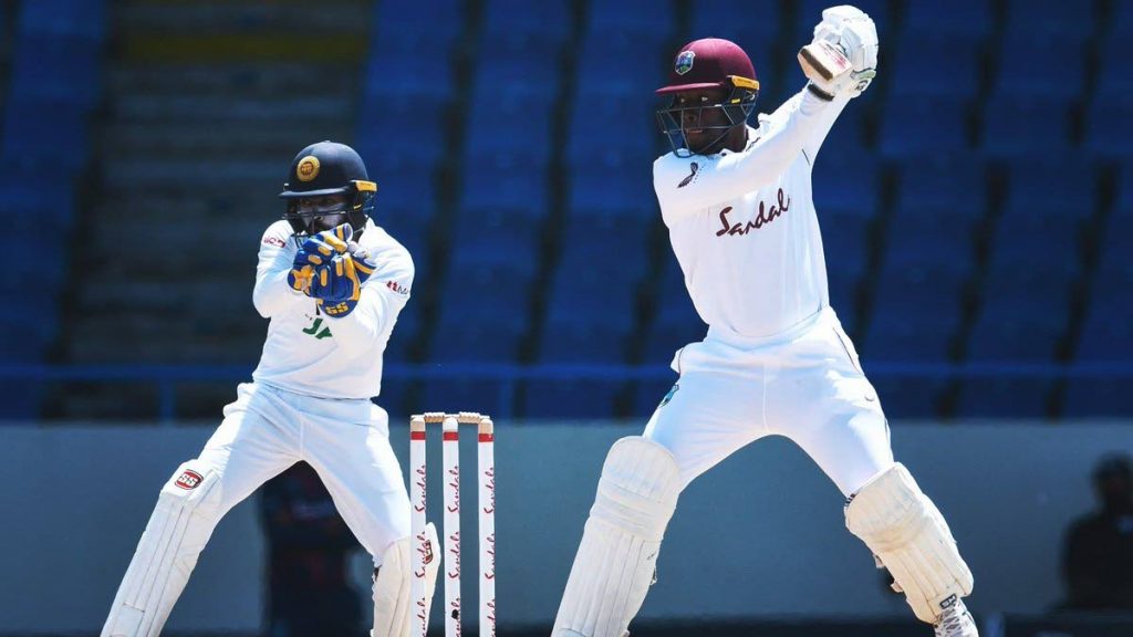 Nkrumah Bonner (R) of West Indies hits 4 as Niroshan Dickwella (L) of Sri Lanka watches during the 5th and final day of the 1st Test at Vivian Richards Cricket Stadium in North Sound, Antigua and Barbuda, on Thursday. - 