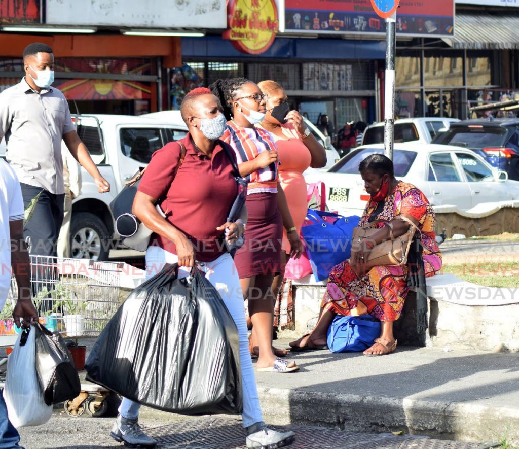 Members of the public show varying levels of adherence to mask wearing protocols at the corner of Charlotte street and Independence Square, Port of Spain on Thursday afternoon. - Vidya Thurab