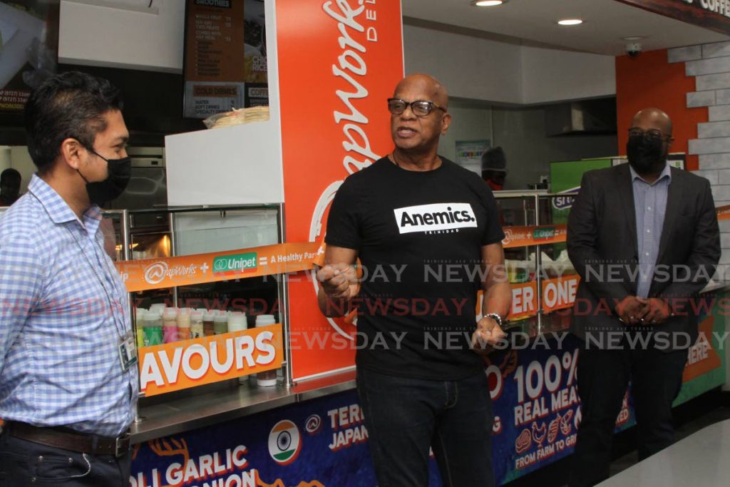Unipet corporate secretary Rupert Jones (left), San Fernando Mayor Junia Regrello  and WrapWorks founder Gerard Edwards at the opening of the new outlet on Saturday. - Photo by Marvin Hamilton