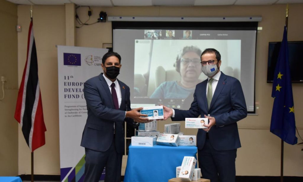 Chief Medical Officer Dr Roshan Parasram, left, receives PPE from  Sanjin Soldatić, Charge d’Affaires at the EU Delegation to Trinidad and Tobago.  On screen, Dr Joy St John, Caribbean Public Health Agency executive director looks on. Photo courtesy Caribbean Public Health Agency.  - 