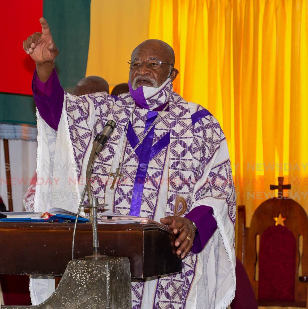 LIFT YOUR VOICES: Archpriest Anthony Phillip leads members of the Mt Bethel Spiritual Baptist Church at Pump Mill in singing songs of praise on the occasion of Spiritual Shouter Baptist Liberation Day on Tuesday. - DAVID REID