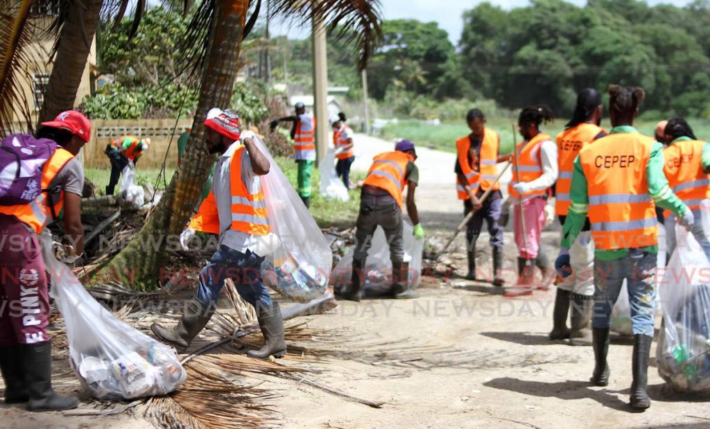 IN this July 10, 2019 file photo CEPEP workers clean up debris and garbage on Manzanilla beach. File photo/Angelo Marcelle - 