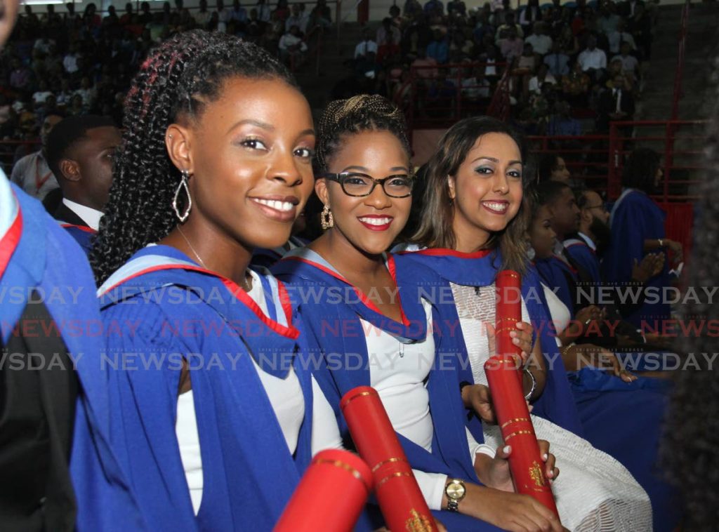 FILE PHOTO: UWI Visual Arts graduates, from left, Akilah Gomez, Anesha Garcia and Rachel Christa Gangadeen display their scrolls at their graduation the St. Augustine Campus, October 26, 2019. A report suggests UWI students should pay 40 per cent rather than 20 per cent of their tuition costs. - 