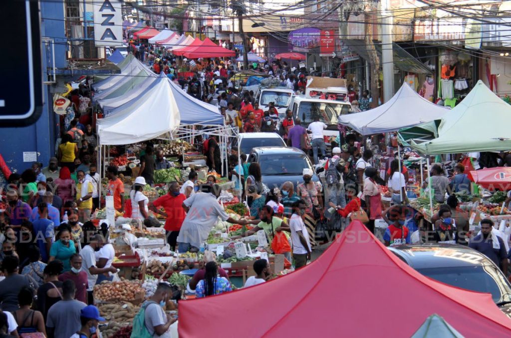 In this December 24, 2020, people do their Christmas shopping on Charlotte St, Port of Spain. According to the latest ACCA and IMA GECS survey, the global economy is bouncing back in terms of confidence, orders, employment and spending. Photo by Ayanna Kinsale